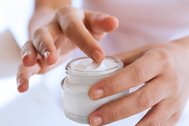 Woman's hand touching on the cream for applying
